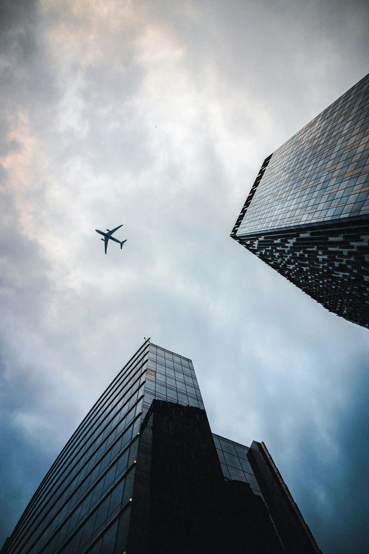 airplane flying over the building during daytime